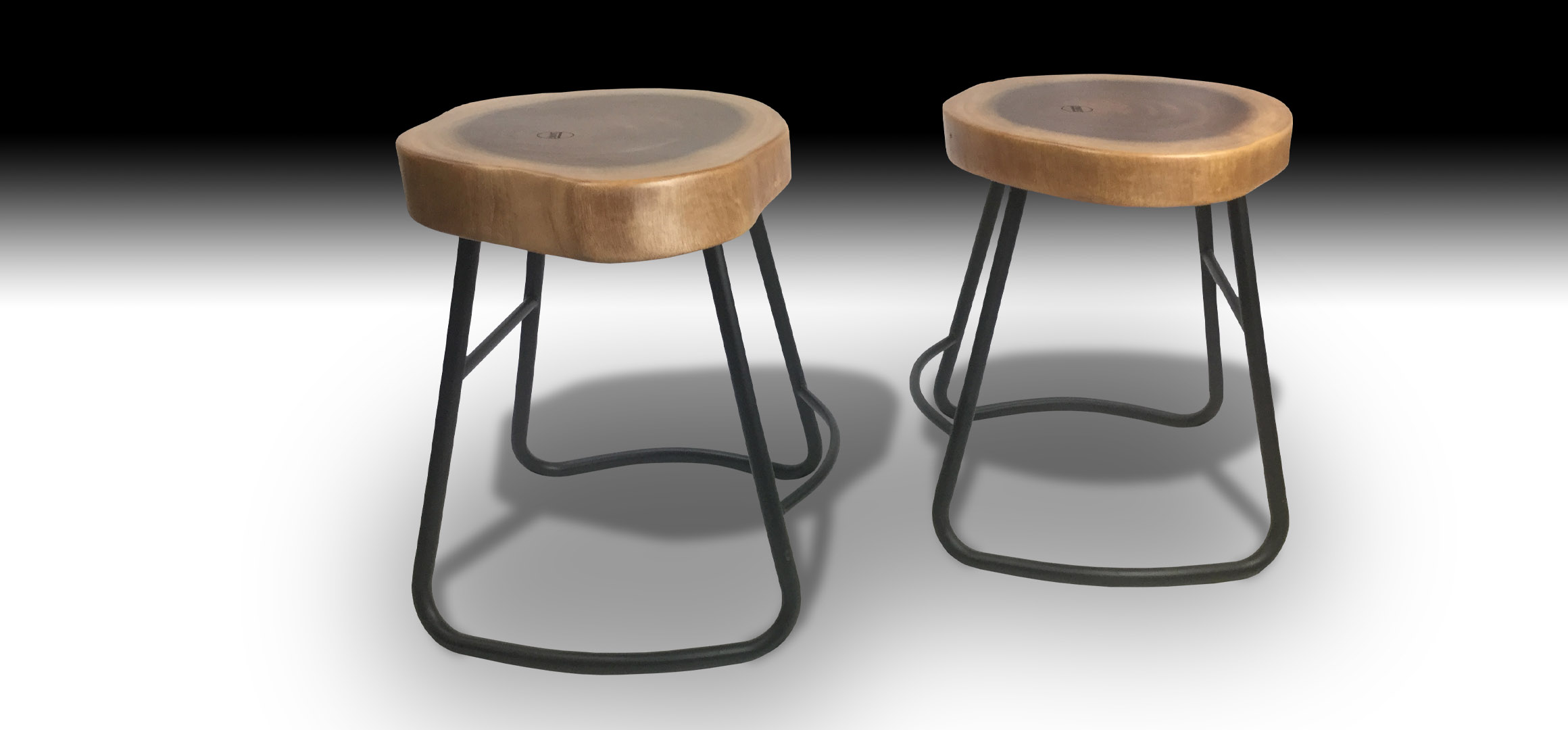 Two Julian Suar wood stools