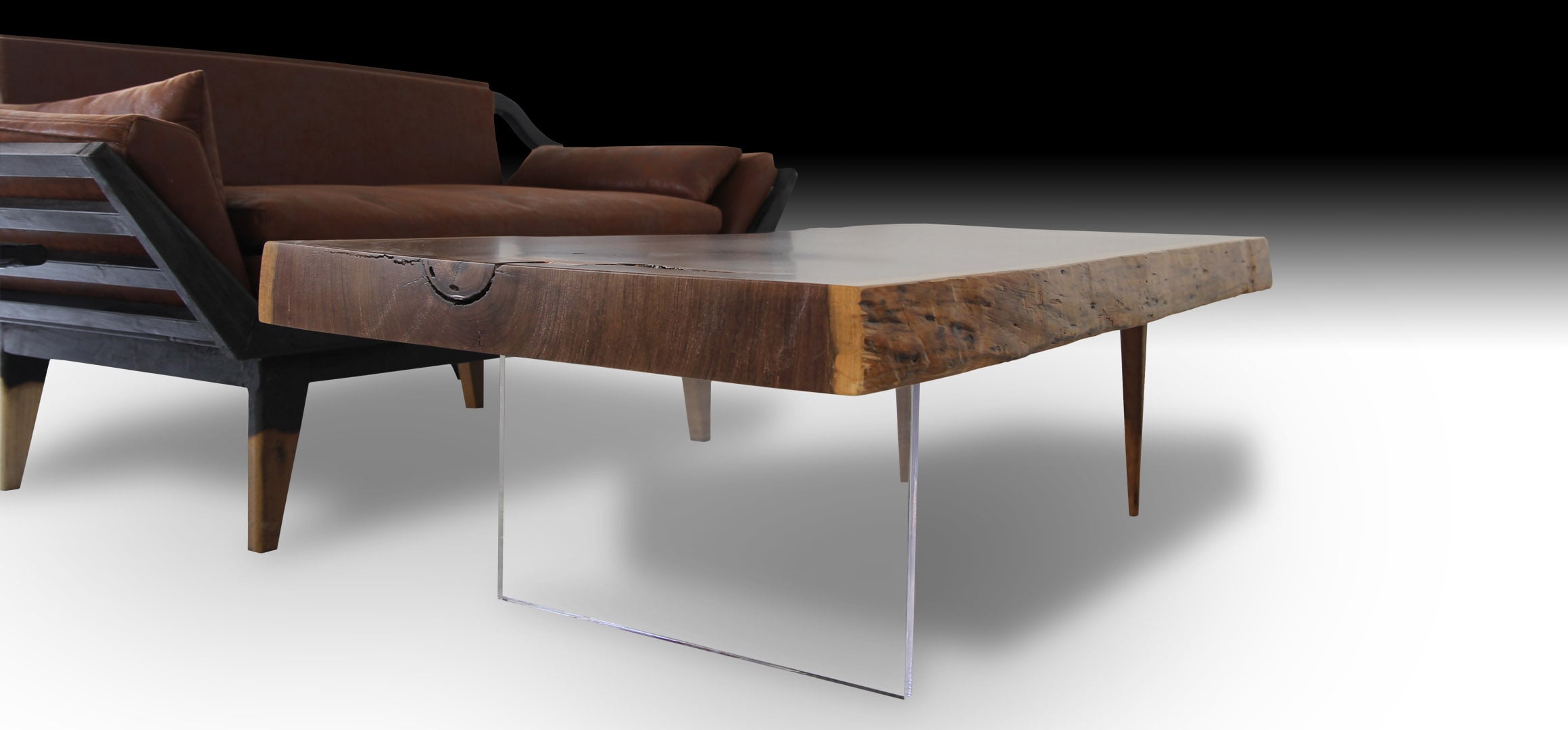 Animal live edge walnut wood coffee table next to a wooden sofa