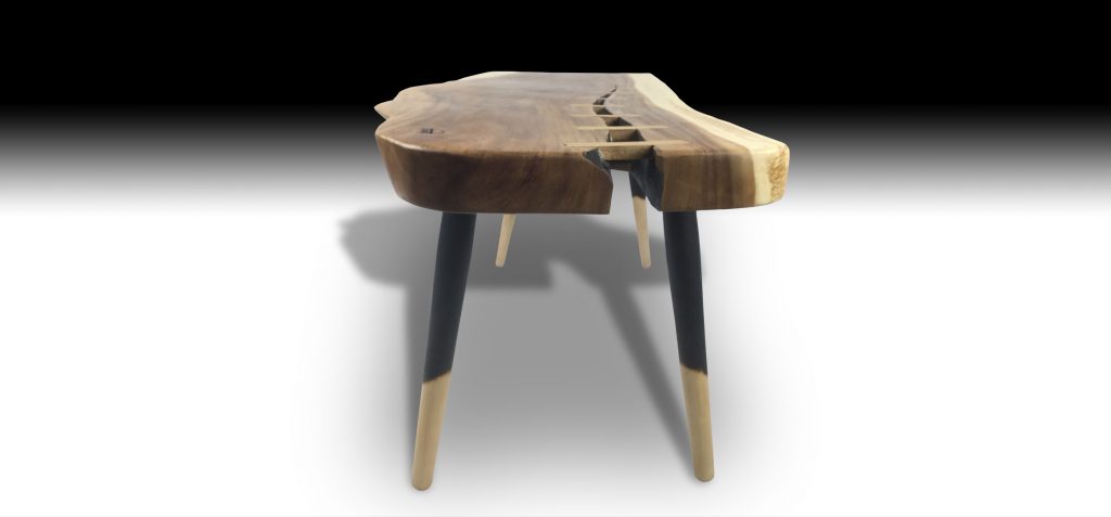 Branca live edge Suar wood coffee table with natural crack and pencil legs side view
