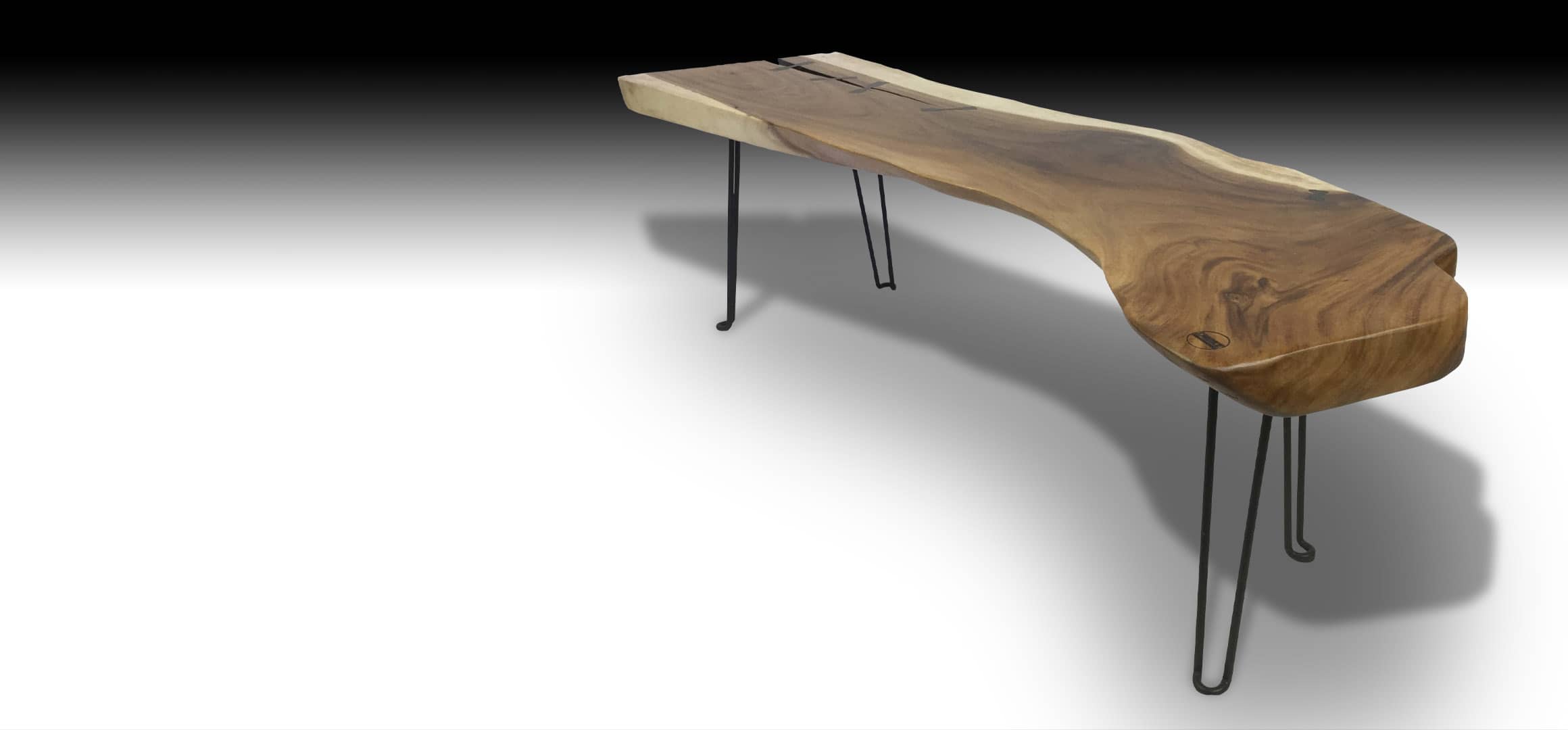 Rika live edge Suar wood coffee table with metal legs diagonal view